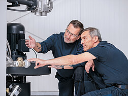 CERTUSS employees inspecting a steam system